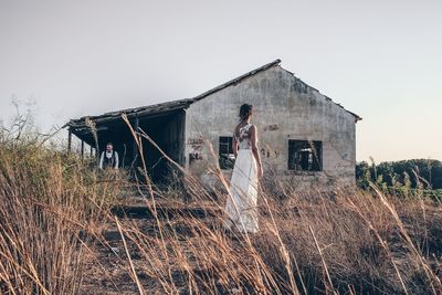 Abandoned house on field against clear sky