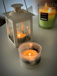 High angle view of illuminated tea light candles on table