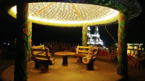 Illuminated amusement park ride at night