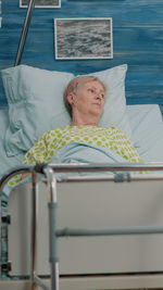 Portrait of young woman sleeping on bed at home
