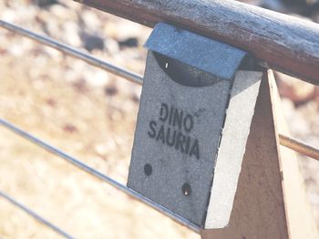 High angle view of text on metal fence