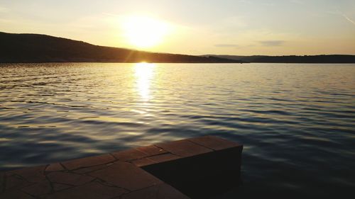 Surface level view of calm sea at sunset