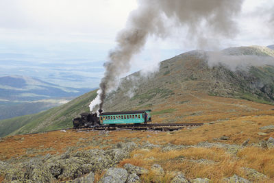 Steam train of mount washington cog railway is pushing up to the summit at good weather conditions