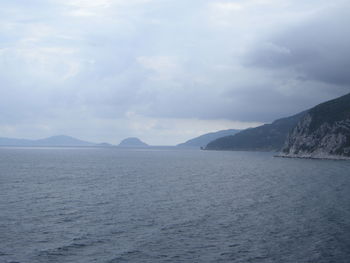 Scenic view of mountains against cloudy sky