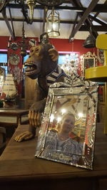 Close-up of statue against illuminated store