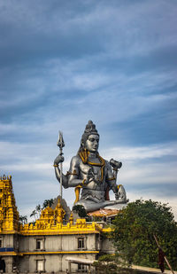 Low angle view of statue against sky