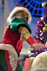 Close-up of boy with christmas tree at night