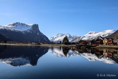 Scenic view of lake and snowcapped mountains against sky