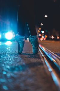 Low section of person tiptoeing by railroad tracks