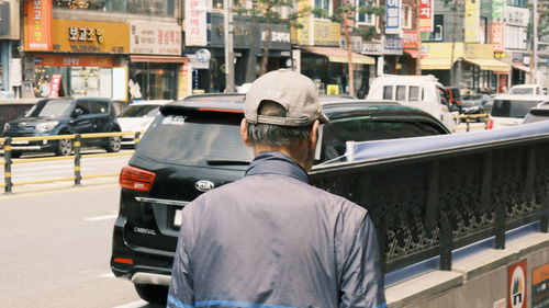 Rear view of man on street in city