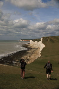 Man standing on shore against sea