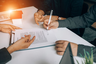 High angle view of man holding paper on table