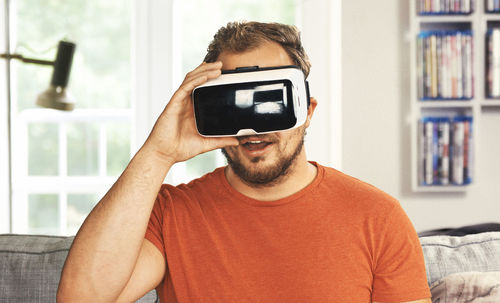 Portrait of young man using virtual reality simulator