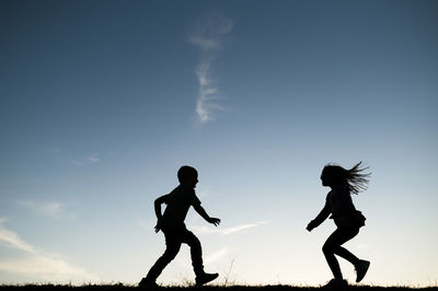 Silhouetted children running together in waco texas