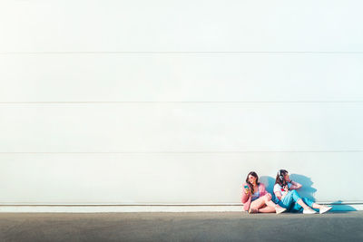 High angle view of people sitting on floor against wall