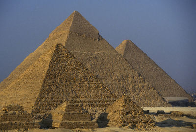 Old stone pyramids against clear sky