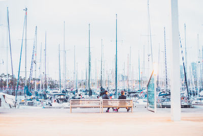 Sailboats moored in harbor