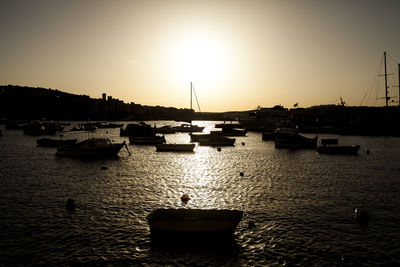 Sailboats in marina at sunset