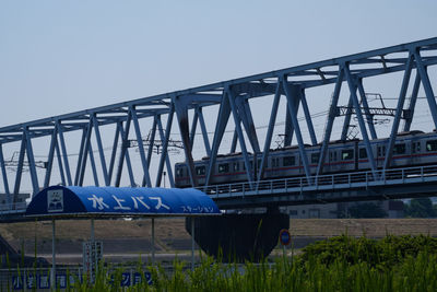 Low angle view of train on bridge against sky