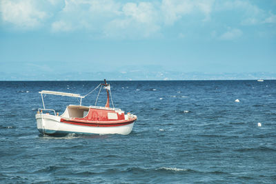 Sailboat sailing in sea against sky