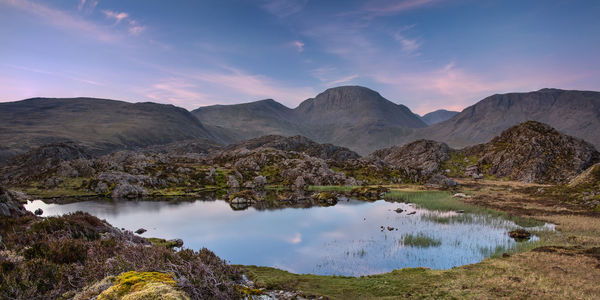 The warm morning light on the lakeland mountain of great gable reflecting in innominate tarn