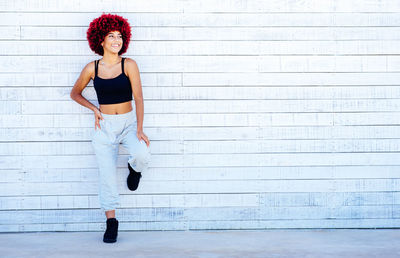 Portrait of woman leaning against wall