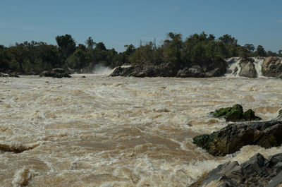 Scenic view of waterfall against clear sky