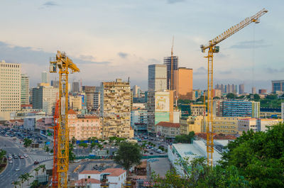 View of cityscape against cloudy sky
