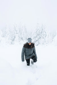Man standing on snow covered mountain