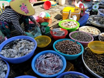 High angle view of people for sale at market stall