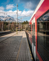 Train at railroad station against sky