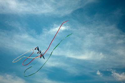 Low angle view of kites against sky