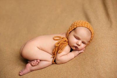 High angle view of cute naked baby sleeping