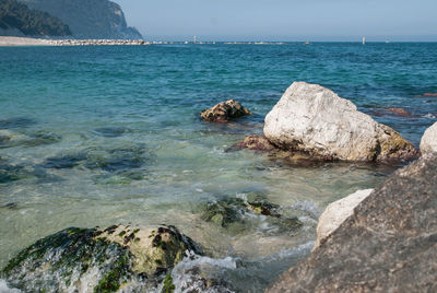 Rocks in sea against sky