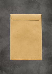 High angle view of yellow paper on wall