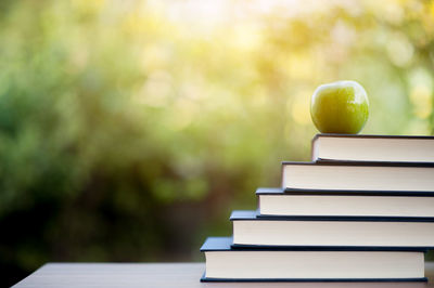 Close-up of apple on books