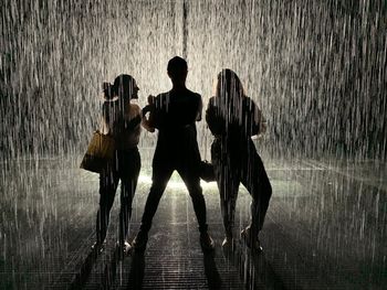 Group of people walking on road during rainy season