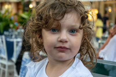 Close-up portrait of girl with curly hair