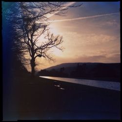 Scenic view of landscape against sky at sunset