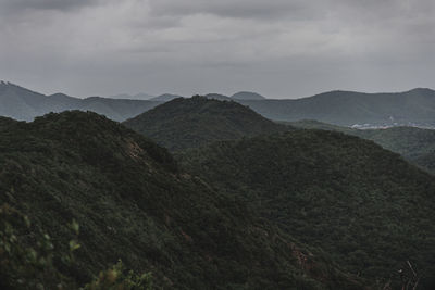 Scenic view of mountains against cloudy sky