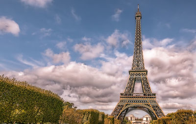 Low angle view of tower against cloudy sky