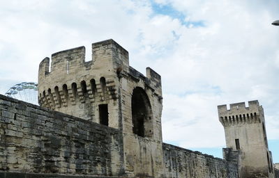 Low angle view of historic building against cloudy sky