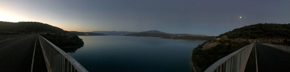 Scenic view of dam by lake against sky