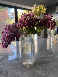 Flowers in glass vase on table