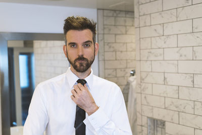 Portrait of businessman in restroom