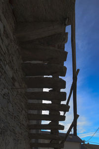 Low angle view of spiral staircase of building against sky