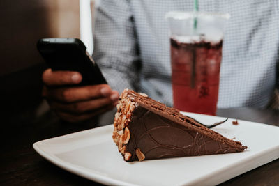 Midsection of man using laptop on table