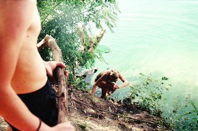 Close-up of shirtless young woman in water at beach