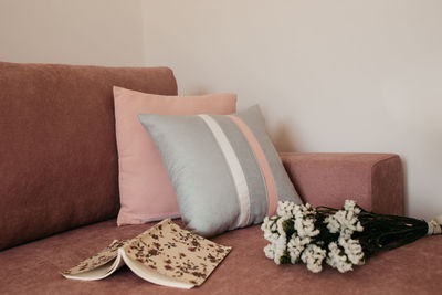 Close-up of sofa on table against wall at home