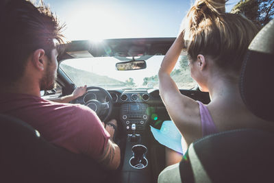 Rear view of woman sitting in car